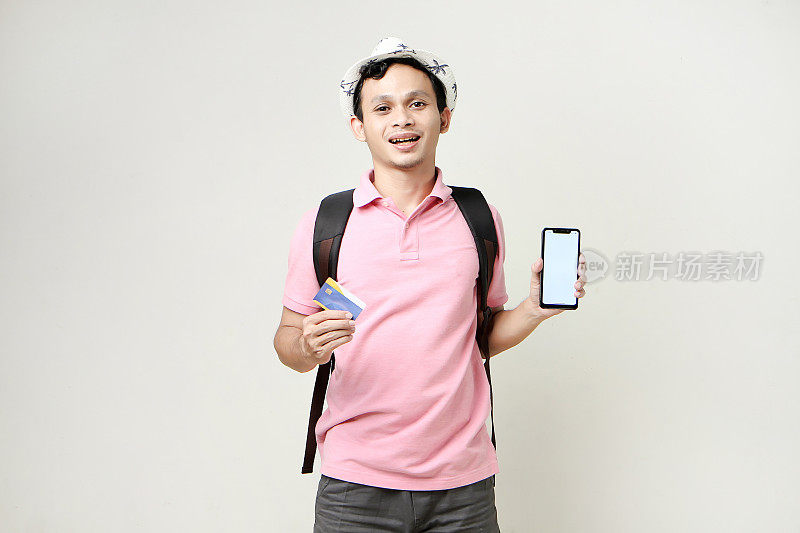 Asian man backpacker holding mobile phone and credit card. digital nomad and travelling concept. on isolated background